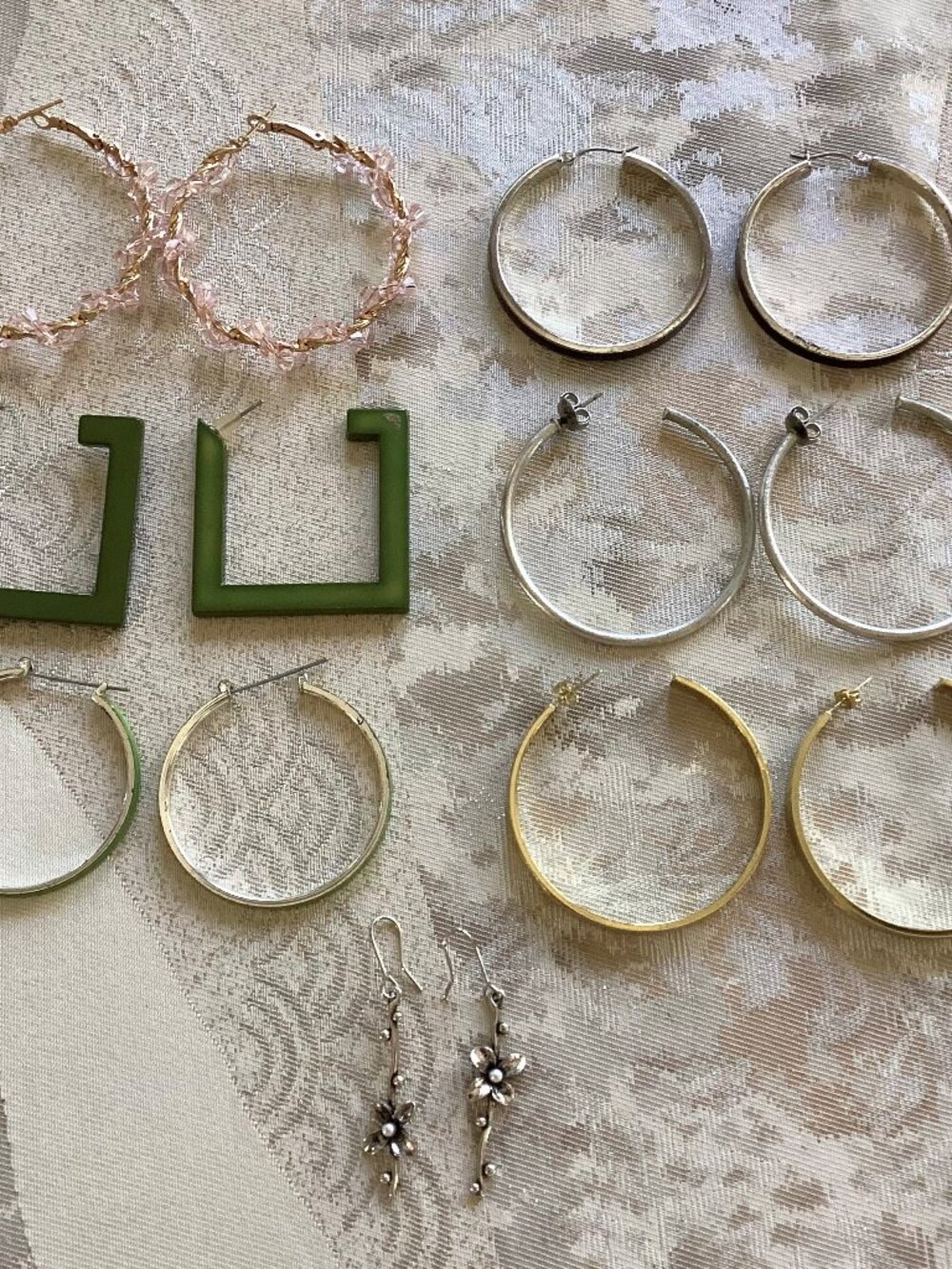 7 pairs of earrings-pink, black, silver, green & gold hoops, plus silver flowers